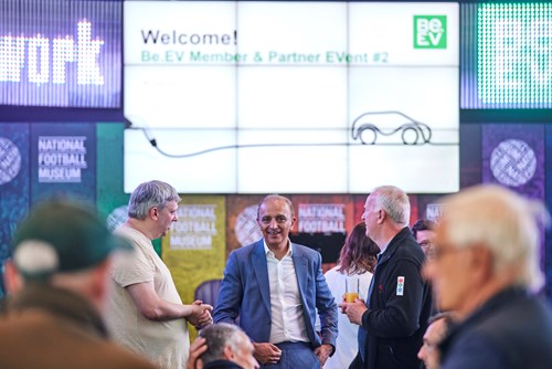 Asif, Be.EV's CEO, speaking with two men in front of a presentation